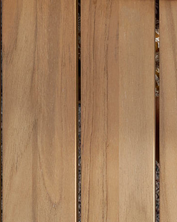 Glass of lemon water on a Neighbor teak outdoor dining table 