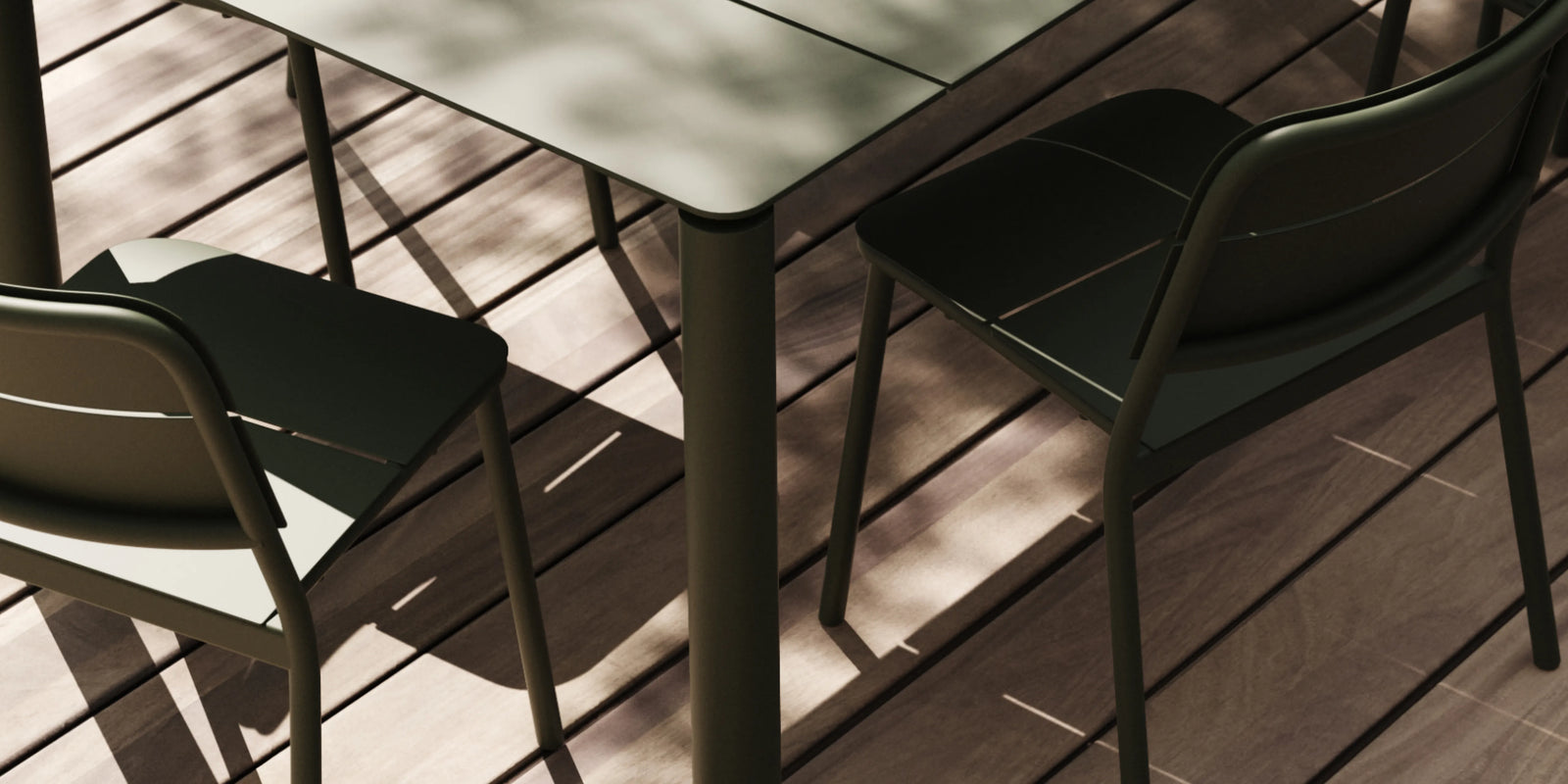 Overhead view of Neighbor Bandwidth Dining Table and chairs in Olive on a wood deck, deep shadows