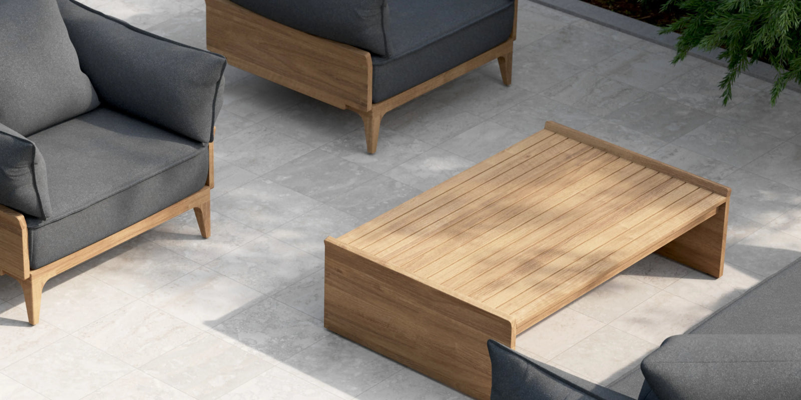 Closeup of Neighbor Bluff collection with charcoal sofas and teak coffee table on travertine patio