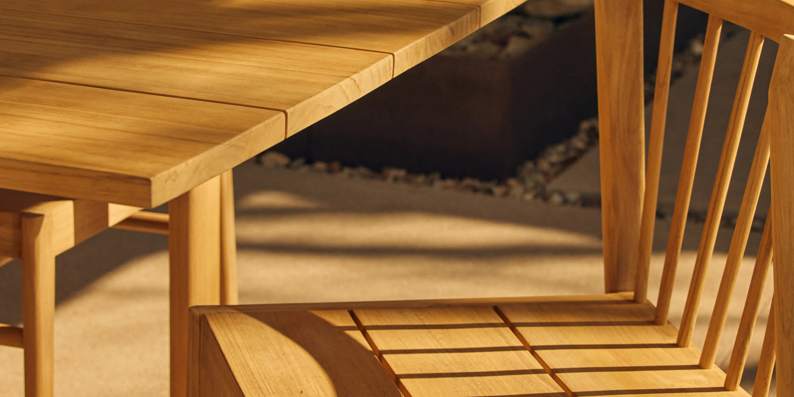 Closeup of Neighbor Felloe Dining Chair teak back spindles casting shadow in warm afternoon light