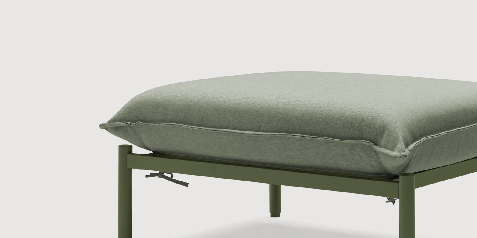 Neighbor Terra Ottoman with cream fabric cushion on teak frame on a covered outdoor patio