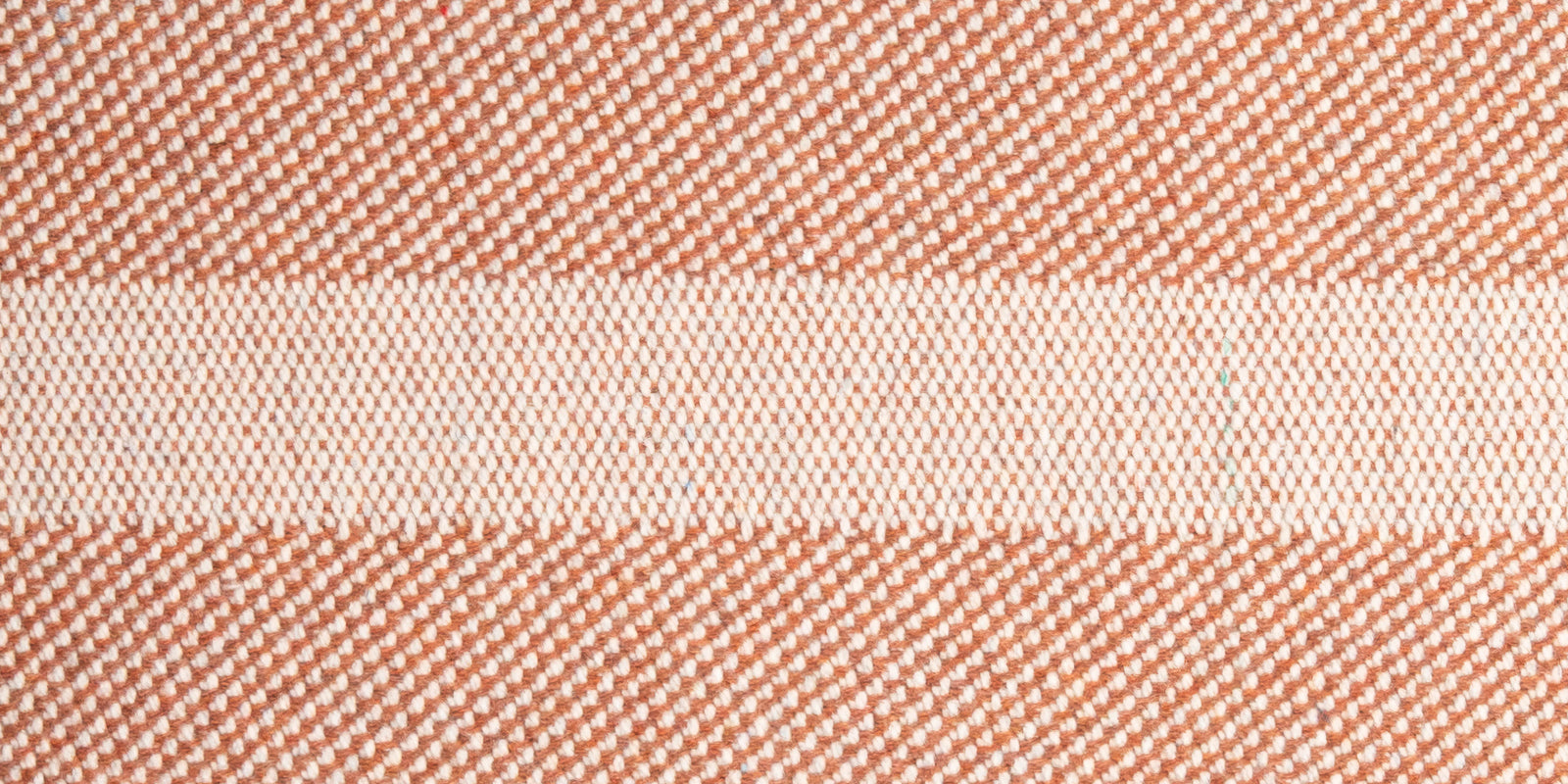 Closeup of Neighbor Glyph Throw Pillow pattern and fabric texture on outdoor sofa