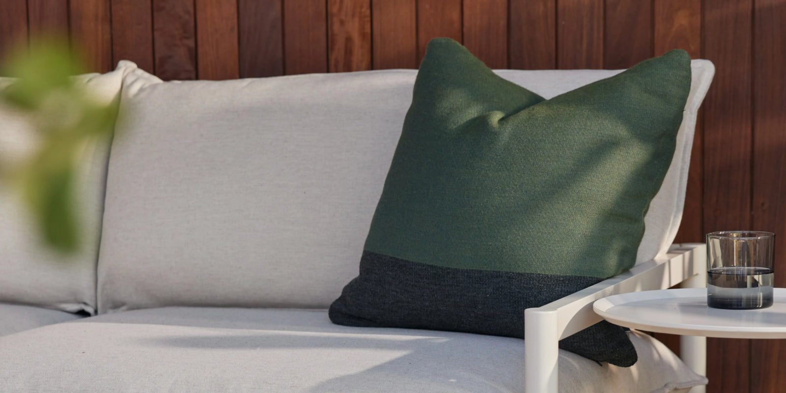 Neighbor Horizon Throw Pillows in mixed tones arranged on outdoor sofa in lifestyle setting