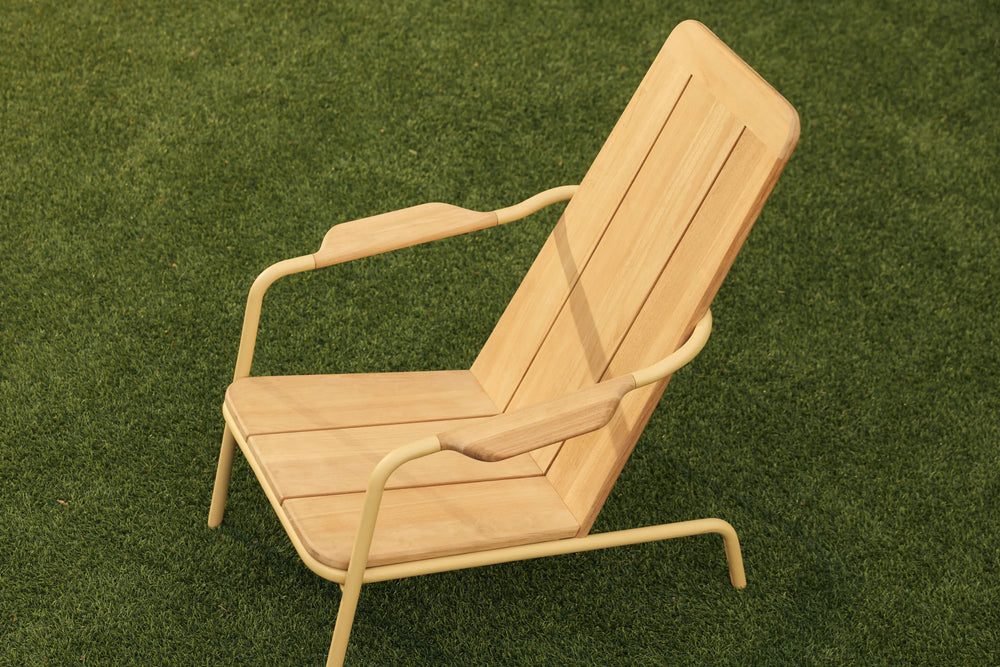 Neighbor Hopper Chair in sand finish, lifestyle shot showing the chair in use on green grass outdoor setting