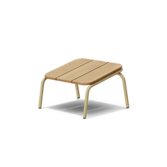 Neighbor Hopper Ottoman in sand finish, three-quarter view, light wood seat with tan metal frame against dark background