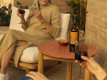 Neighbor Haven Side Table in Paprika finish next to seating, styled for outdoor entertaining with wine and snacks