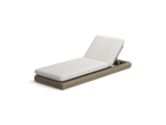 Neighbor Roundabout Sun Lounger with woven all-weather wicker base and a thick cushion, shown in articulated position with the backrest raised, cushion shown in natural wicker tan, three-quarter angle view.