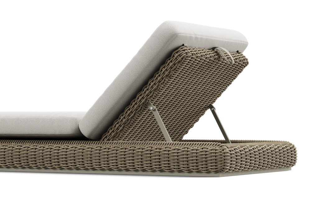 Neighbor Roundabout Sun Lounger with woven all-weather wicker base and a thick cushion, shown in articulated position with the backrest raised, cushion shown in natural wicker tan, low-angle detail view.