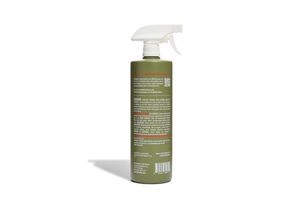 Green spray bottle with a white nozzle on a white background