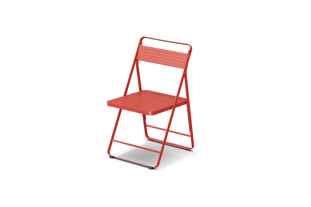 Neighbor Take Two Bistro Chair, an all-metal folding chair with perforated steel seat and backrest in coral red, three-quarter angle view.