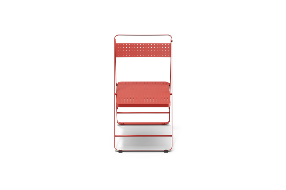 Neighbor Take Two Bistro Chair, an all-metal folding chair with perforated steel seat and backrest in coral red, front view.
