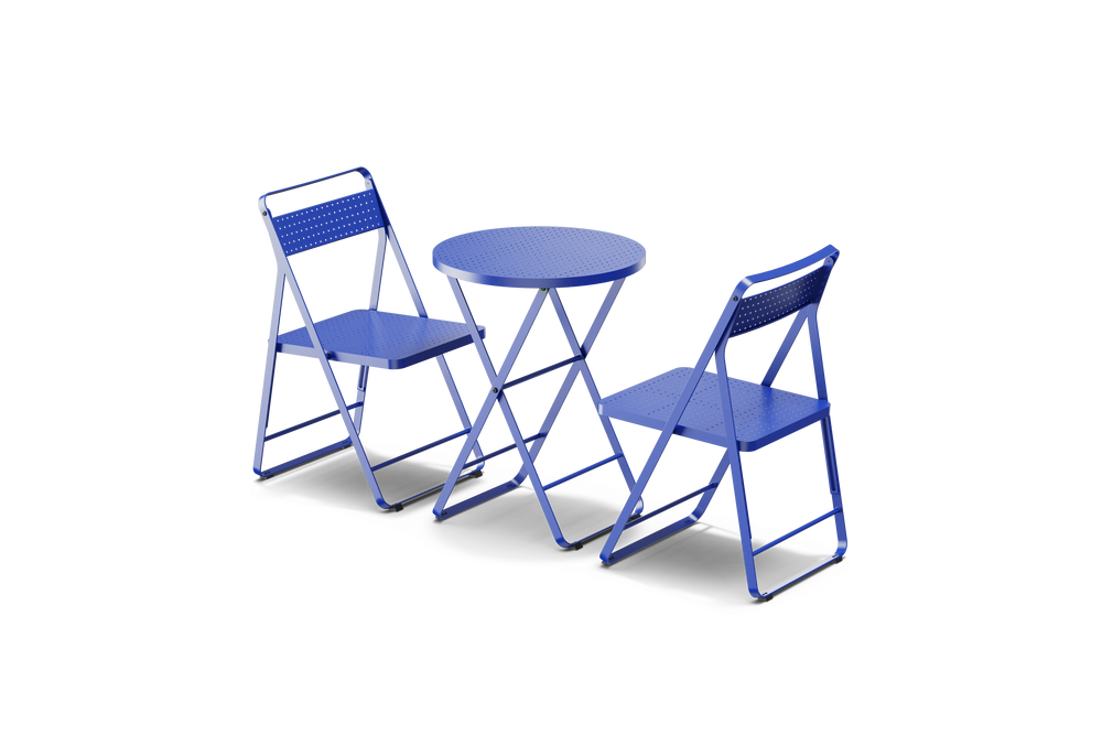 Neighbor Take Two Bistro Set with two perforated-steel folding bistro chairs and a matching round folding bistro table in ultramarine blue, three-quarter angle view.