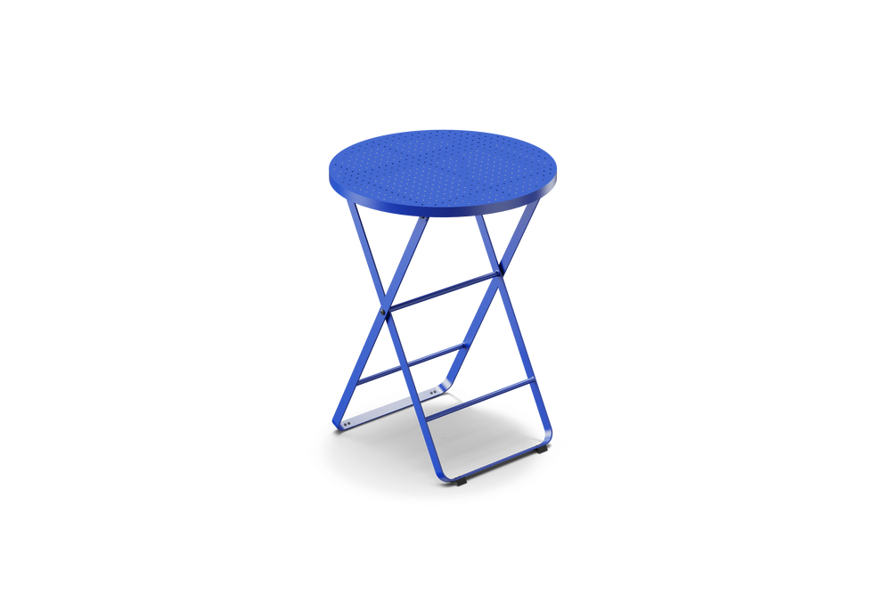 Neighbor Take Two Bistro Table, a small round folding outdoor side table with a perforated steel top in ultramarine blue, three-quarter angle view.
