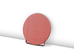 Neighbor Take Two Coffee Table, a round folding outdoor coffee table with a perforated steel top in coral red, shown fully folded for storage.