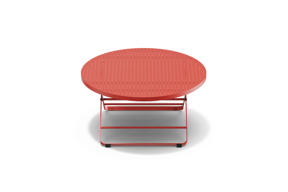 Neighbor Take Two Coffee Table, a round folding outdoor coffee table with a perforated steel top in coral red, front view.
