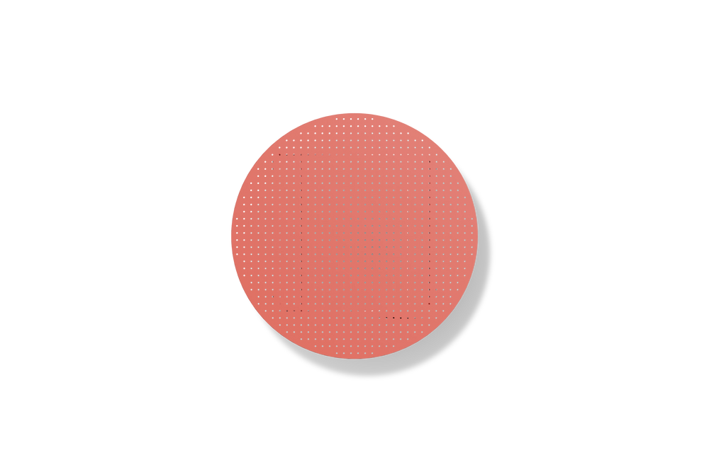 Neighbor Take Two Coffee Table, a round folding outdoor coffee table with a perforated steel top in coral red, overhead view.