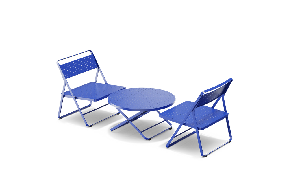 Neighbor Take Two Lounge Set with two perforated-steel folding lounge chairs and a matching round folding coffee table in ultramarine blue, three-quarter angle view.