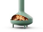 Neighbor Totem Chiminea, a sculptural enameled-steel outdoor fireplace with a rounded firebox and tall chimney on tripod legs in agave sage green enamel finish, three-quarter angle with logs burning inside the firebox.