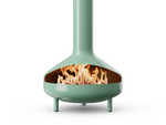 Neighbor Totem Chiminea, a sculptural enameled-steel outdoor fireplace with a rounded firebox and tall chimney on tripod legs in agave sage green enamel finish, front view with logs burning inside the firebox.