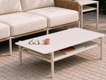 Neighbor Underline Coffee Table in off-white, showing its rounded-corner top, tubular legs and open lower storage shelf.