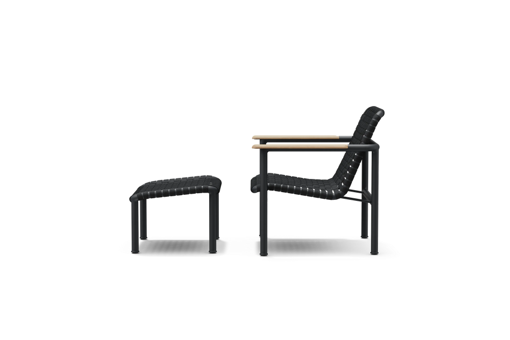 Neighbor Up-Down Chair shown together with the matching Up-Down Ottoman in charcoal black, side profile view.