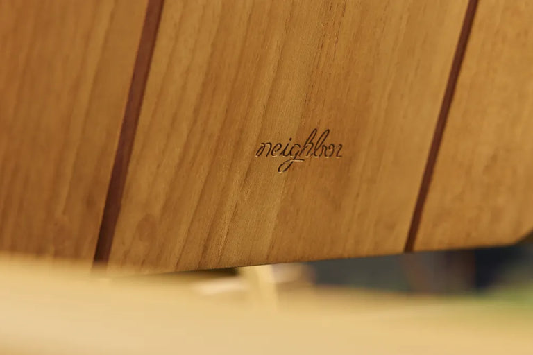 Close-up of Hopper Chair's solid wood seat and metal frame connection, highlighting durable construction detail