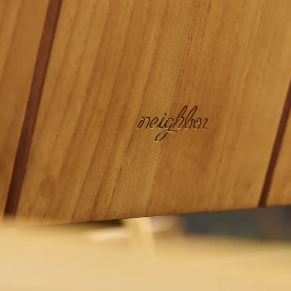Close-up of Hopper Chair's solid wood seat and metal frame connection, highlighting durable construction detail