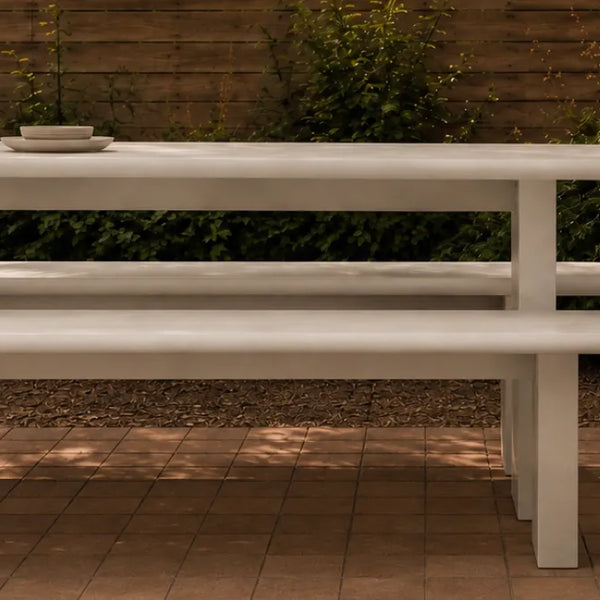 Massif Dining Set in ivory concrete composite: monolithic table with two integrated benches on thick slab legs.
