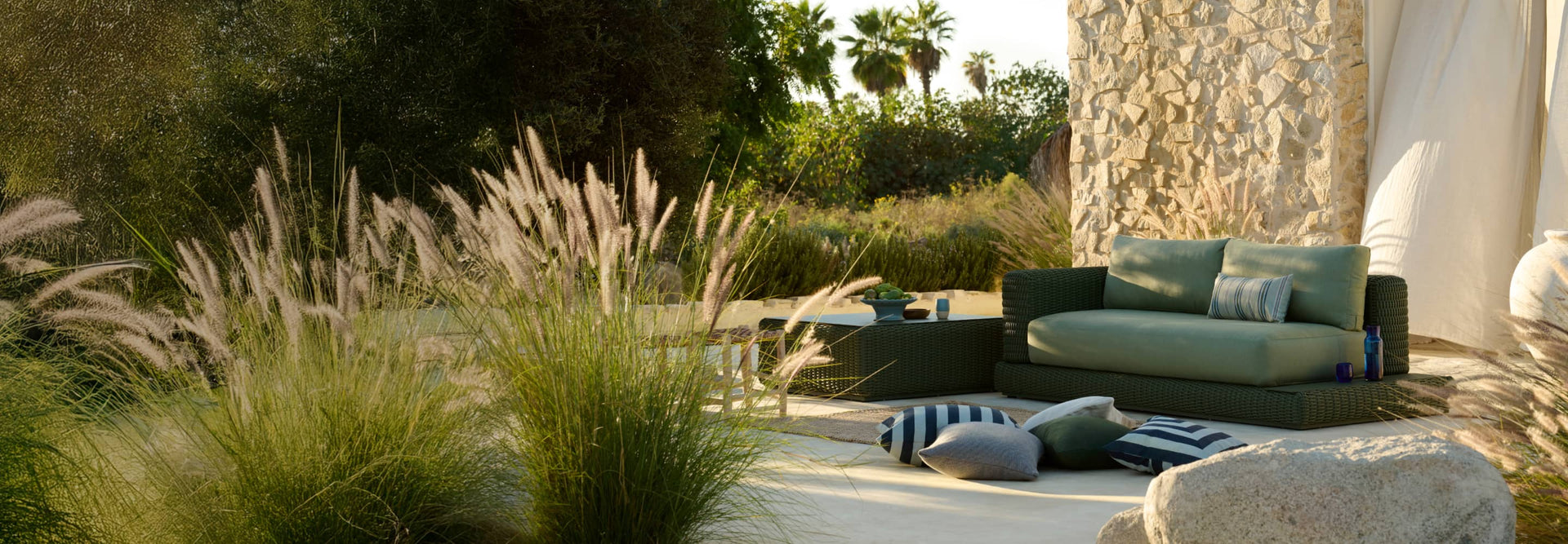 Neighbor green wicker outdoor sofa with built-in side table in luxurious outdoor space