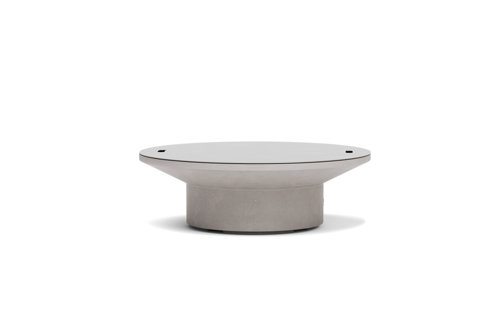 Neighbor Brim Fire Table in Stone, a round pale gray natural gas fire table with a wide flared top, cylindrical base and lid on.