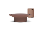 Neighbor Brim Fire Table in Canyon, a round terracotta propane fire table, lid on, beside the cylinder that hides its tank.