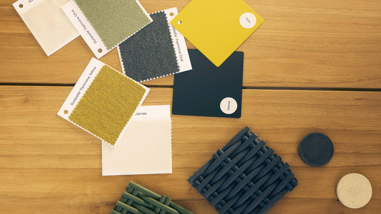 Color swatches and textured samples on a wooden surface