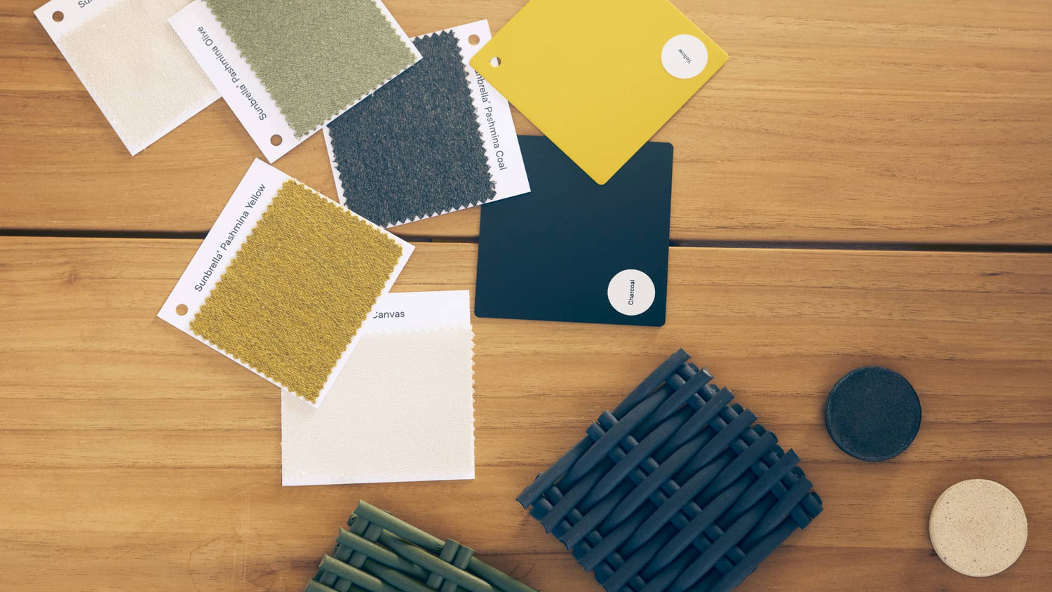 Color swatches and textured samples on a wooden surface