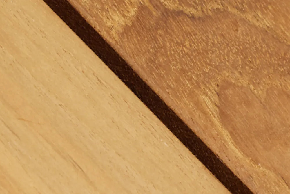 Close-up detail of natural wood showing grain and color variation, highlighting the Hopper Chair's wood craftsmanship