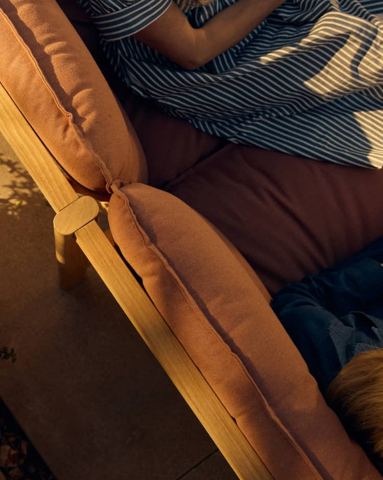 Overhead image of two women sitting and relaxing on an outdoor sectional