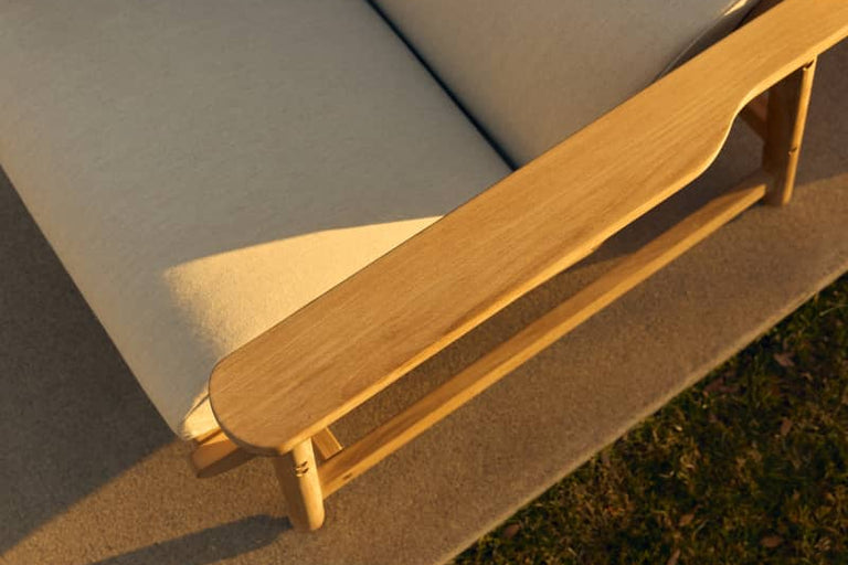 Close detail of the Leedo Deck Chair's teak armrest and Sunbrella fabric