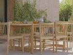 Video of a teak, outdoor dining set. Featuring the Neighbor Felloe Dining Chair, an all teak chair with a wood dowel back.
