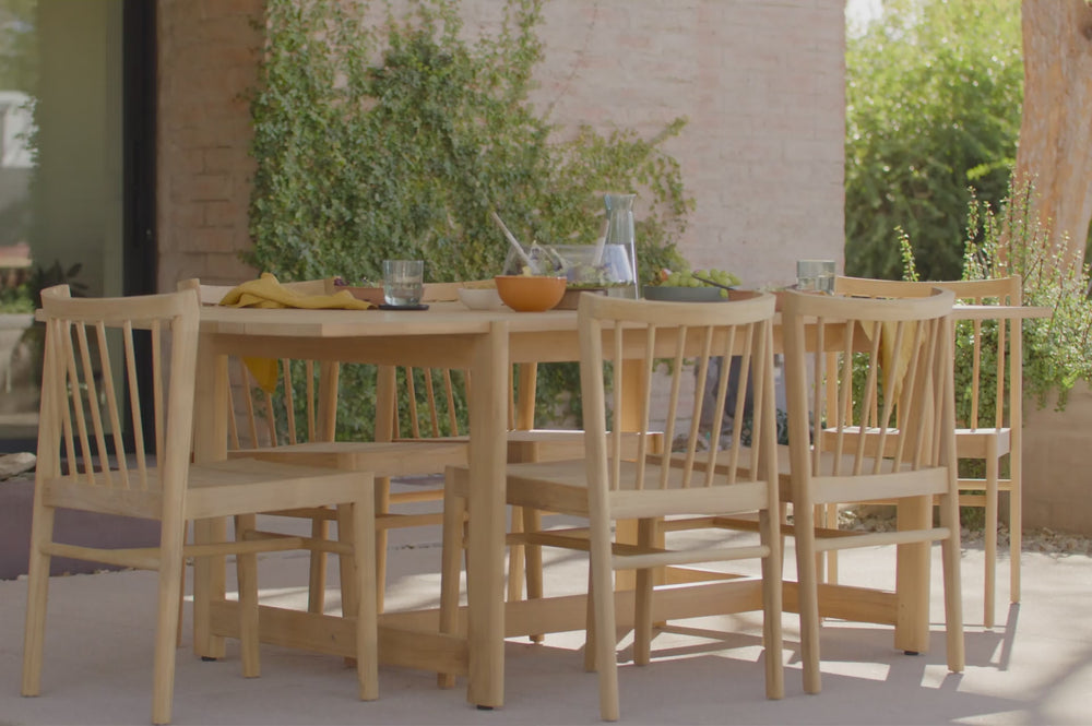 Video of a teak, outdoor dining set. Featuring the Neighbor Felloe Dining Chair, an all teak chair with a wood dowel back. 