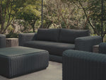 Video of charcoal synthetic rattan furniture, focusing on a sofa with dark charcoal cushions.
