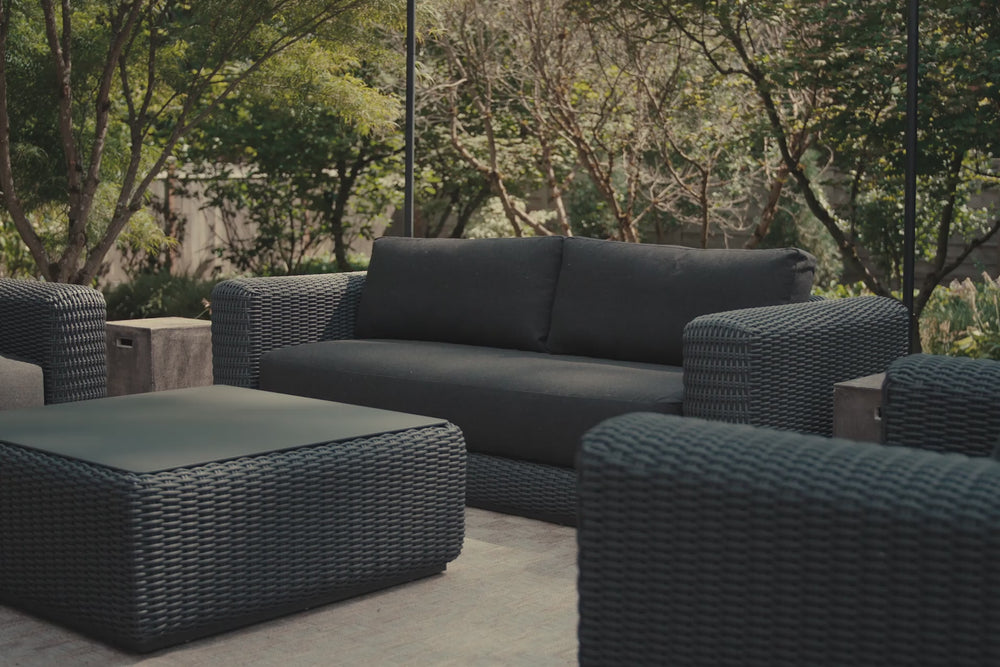 Video of charcoal synthetic rattan furniture, focusing on a sofa with dark charcoal cushions. 