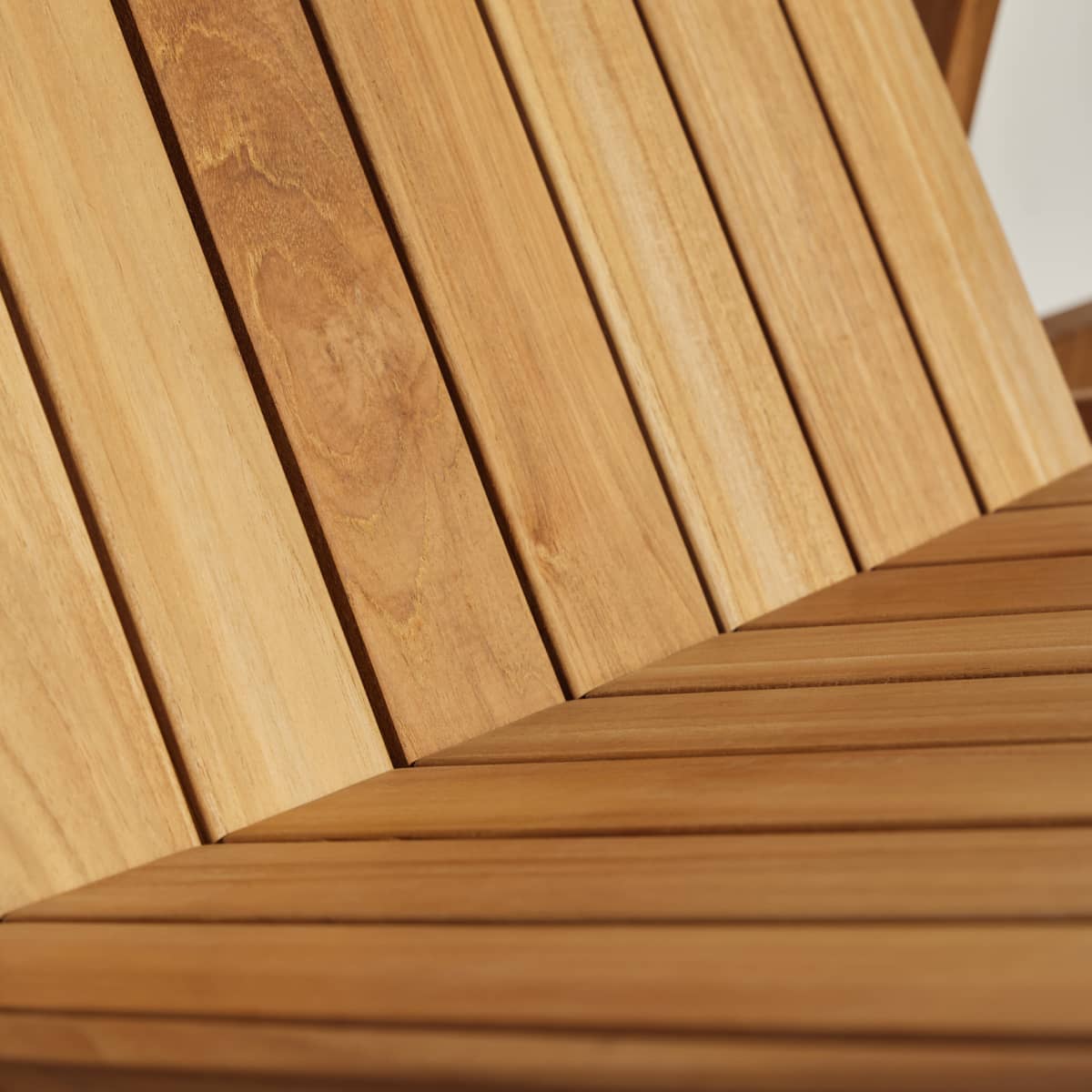 Close-up of teak planks from a portion of outdoor furniture